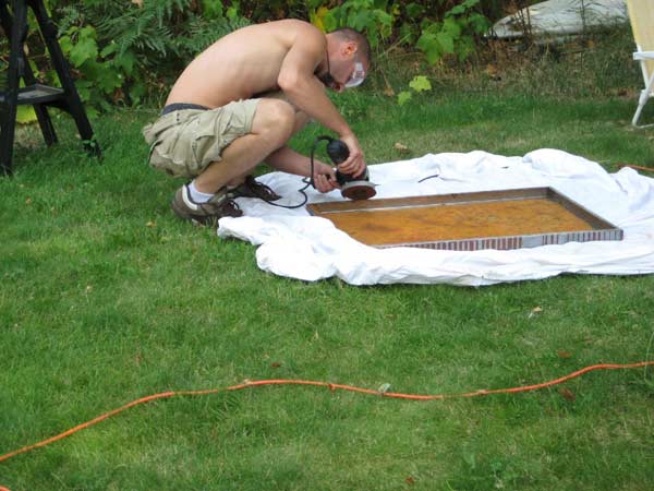 Grinding to finish up steel panel.